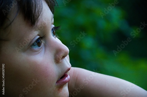 Young boy looking at something off camera with an expression of curiosity