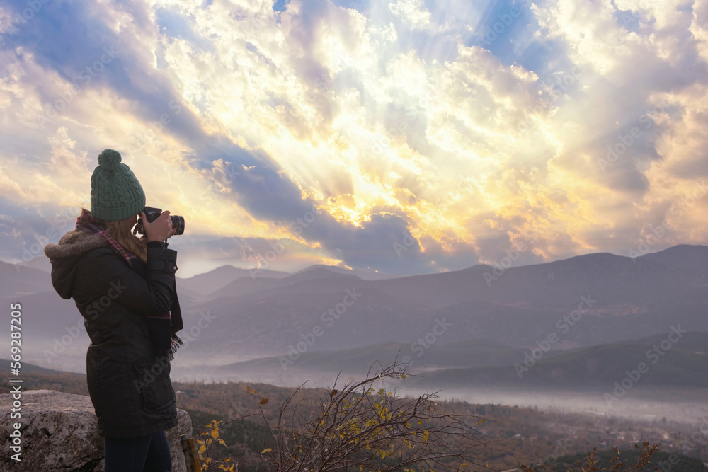 Beautiful young female photographer shooting with professional camera in Outdoor. Beautiful young female photographer shooting with professional camera in Outdoor.