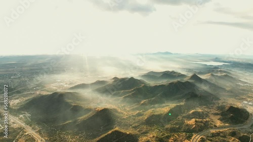 high drone flight recording mountains with haze high drone flight between mountains with mist in the morning