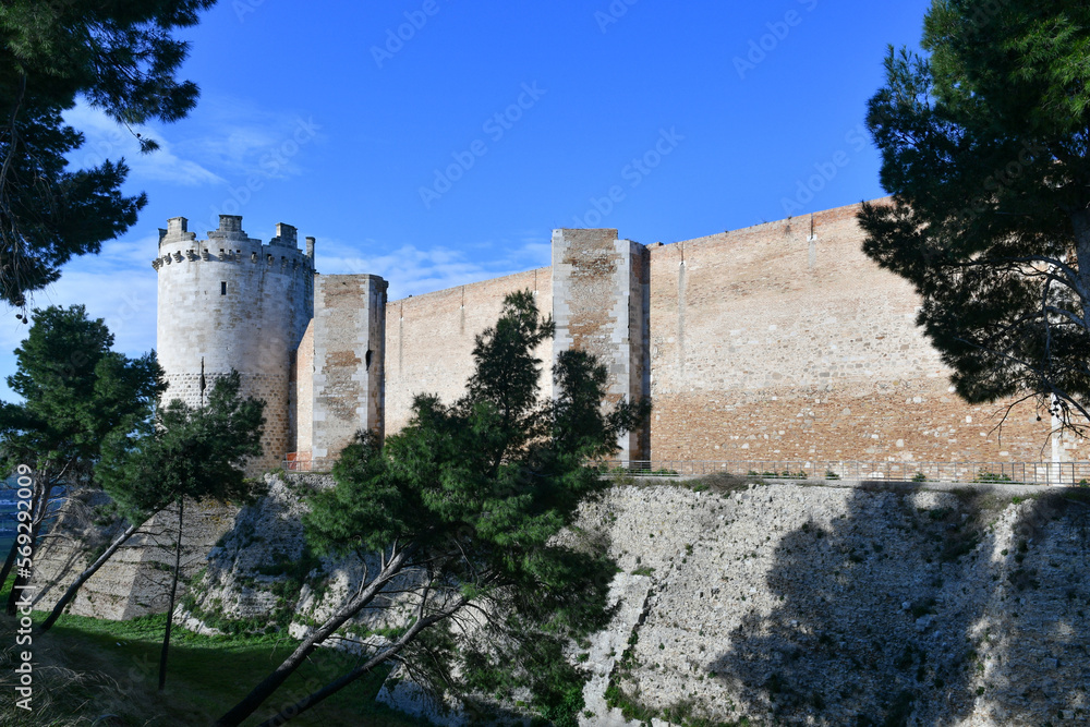 View of the outer walls of an imposing medieval castle of Lucera. It is located in Puglia in the province of Foggia, Italy.