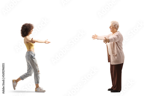 Full length profile shot of a young woman meeting her grandmother