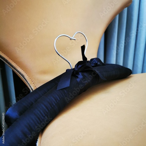 Two silk hangers lie on the armchair.