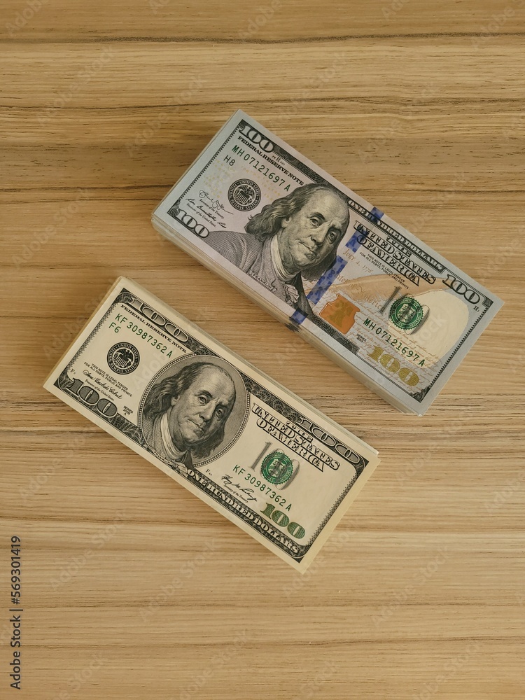 two stacks of 100 dollar bills lie on the table two stacks of 100 dollar bills lie on the table