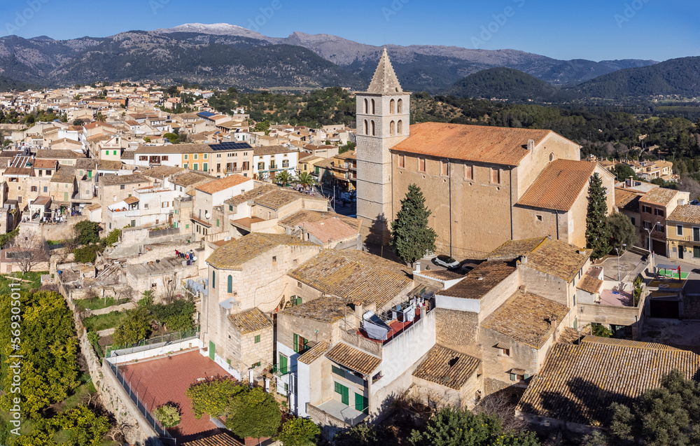 Church of the Immaculate Conception and Campanet village with the snow-capped Sierra de Tramuntana in the background, Majorca, Balearic Islands, Spain