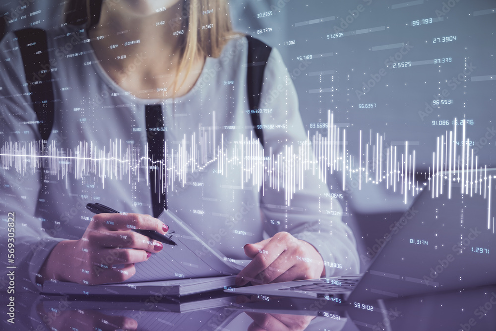 Double exposure of businesswoman hands typing on computer and financial graph hologram drawing. Stock market analysis concept. Double exposure of businesswoman hands typing on computer and financial graph hologram drawing. Stock market analysis concept.