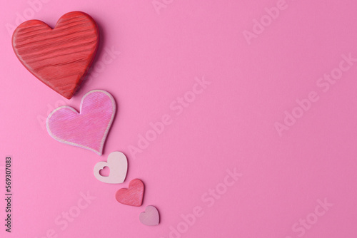 Various valentine’s hearts on pink background with copy space. Valentine’s Day creative greeting card template
