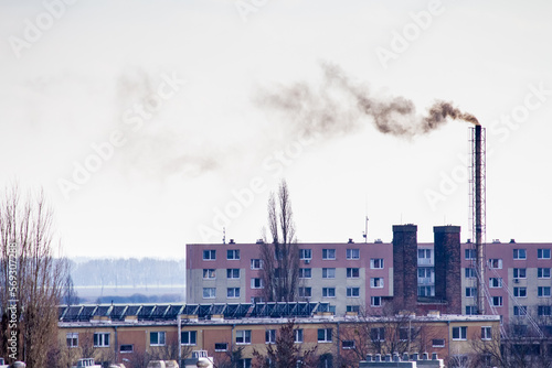 Wallpaper Mural  Chimneys of a solid fuel boiler house in the center of a European city. Pollution of the environment by combustion products of solid fuel, for heating apartments. Torontodigital.ca