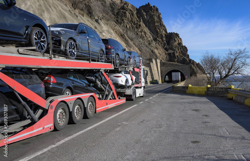 Car transporter carries. Sale and purchase of new vehicles. No logo, brand.