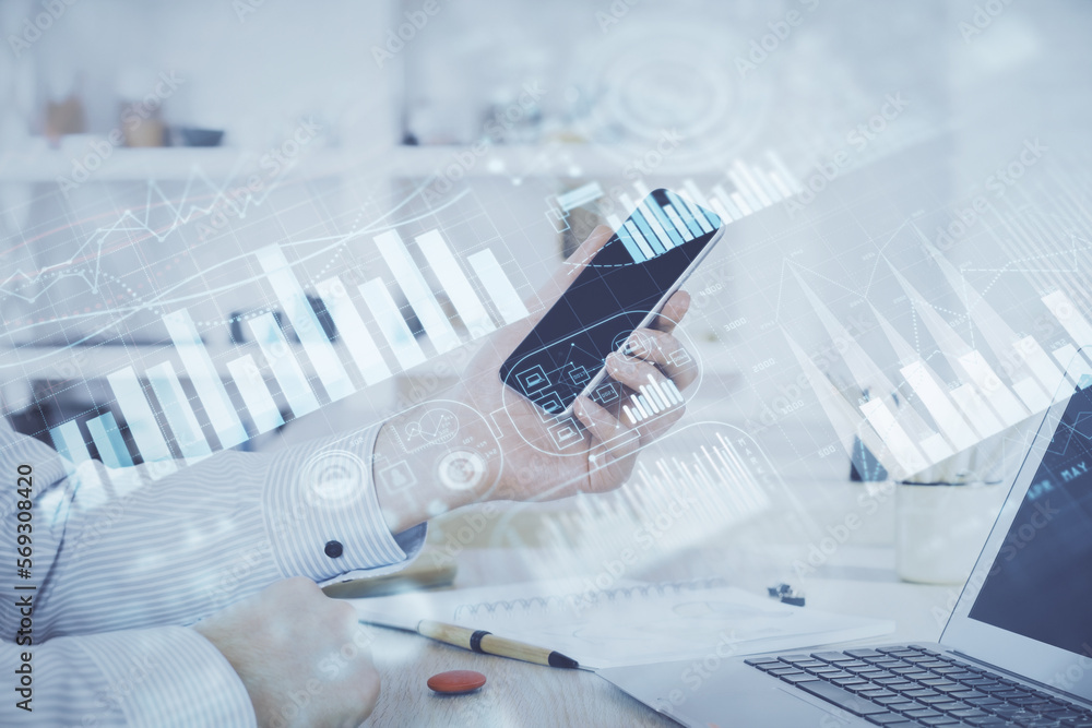 Double exposure of man's hands holding and using a digital device and forex graph drawing. Financial market concept. Double exposure of man's hands holding and using a digital device and forex graph drawing. Financial market concept.