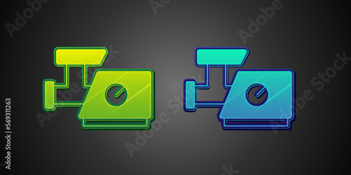 Green and blue Kitchen meat grinder icon isolated on black background. Vector