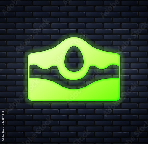Glowing neon Acne icon isolated on brick wall background. Inflamed pimple on the skin. The sebum in the clogged pore promotes the growth of a bacteria. Vector