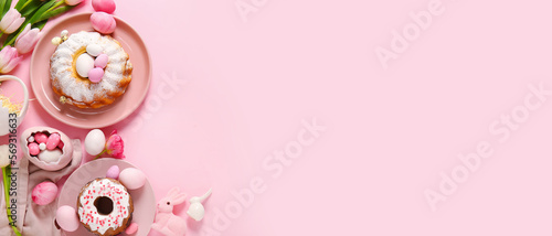 Tasty Easter cakes, painted eggs and flowers on pink background with space for text © Pixel-Shot