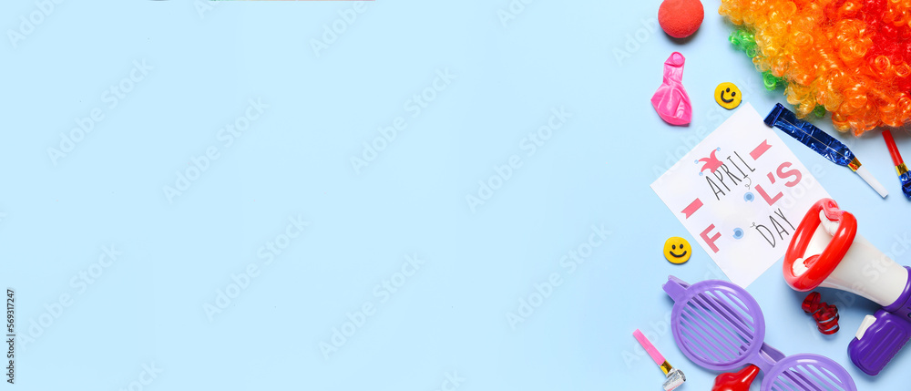 Composition with card and party decor for April Fool's Day celebration on blue background with space for text Composition with card and party decor for April Fool's Day celebration on blue background with space for text