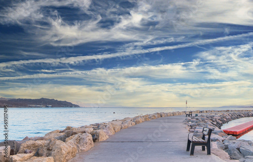 Central  stone public walking promenade with marina for pleasure motorboats i...