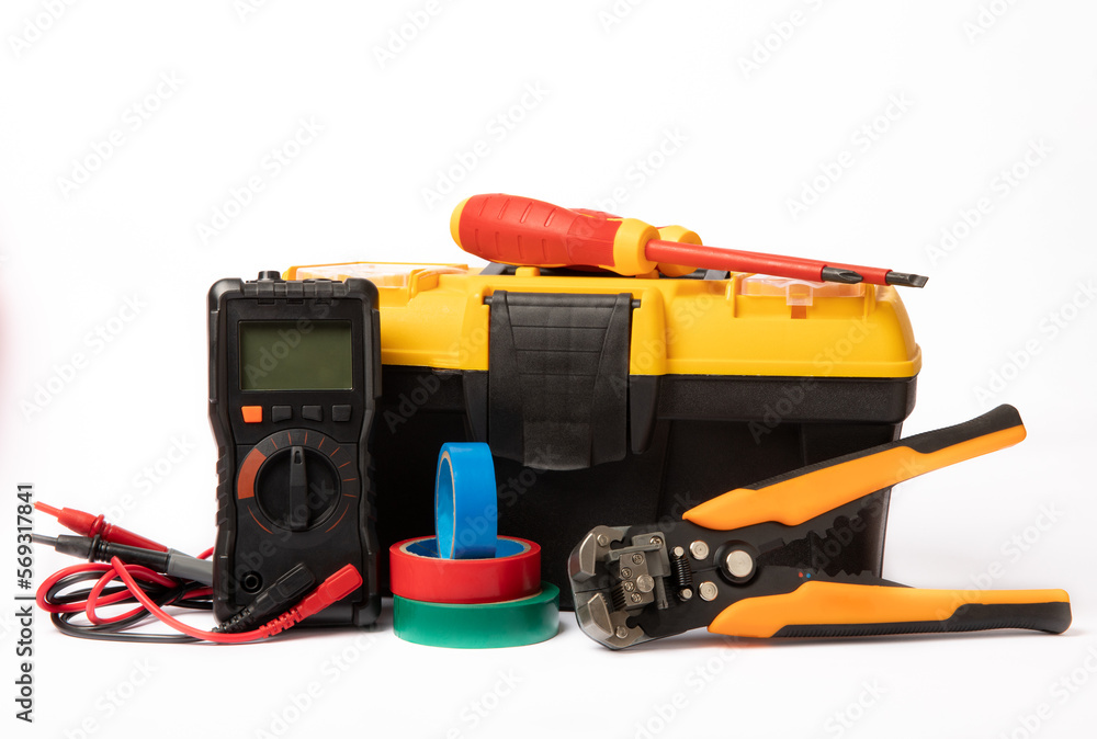Toolbox isolated on white background.Box with electrician's tools. Multimeter, construction tape, electrical tape, screwdrivers, pliers and an automatic insulation stripper. Toolbox isolated on white background.Box with electrician's tools. Multimeter, construction tape, electrical tape, screwdrivers, pliers and an automatic insulation stripper.