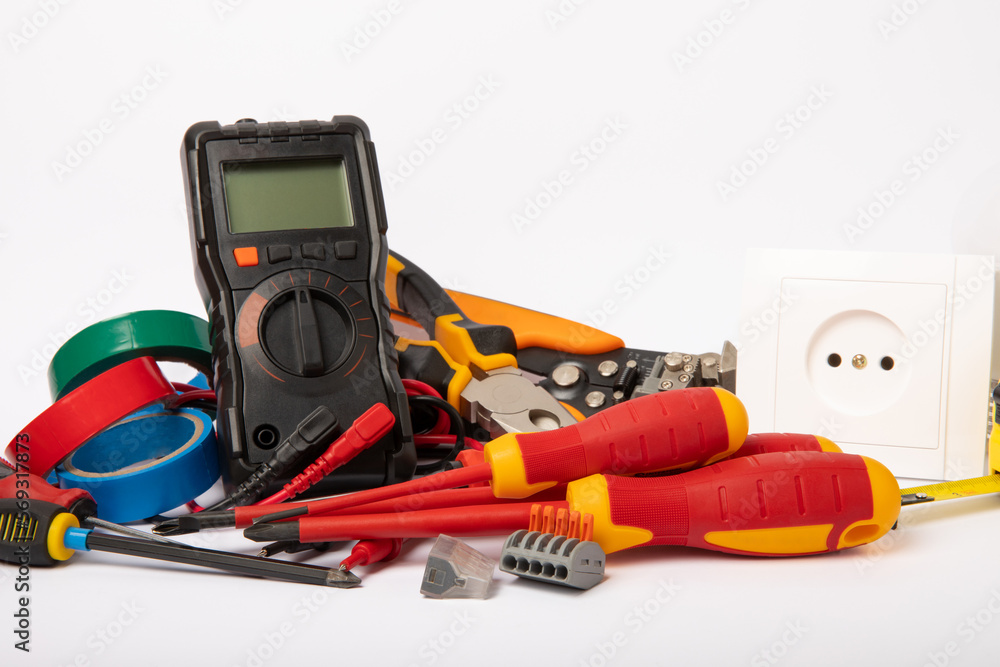Electrician tools isolated on white background.Electrician tools set. Multimeter, construction tape, electrical tape, screwdrivers, pliers, LED lamp, socket, switch and automatic insulation stripper. Electrician tools isolated on white background.Electrician tools set. Multimeter, construction tape, electrical tape, screwdrivers, pliers, LED lamp, socket, switch and automatic insulation stripper.