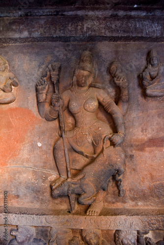 Sculptue of Goddess Durga or Mahishasuramardini slaying the buffalo-demon Mahishasura in cave 1 of the Badami caves complex in Karnataka, India photo