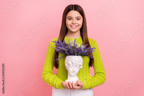 Photo portrait of cute young girl attend art classes hold antique head vase dressed stylish green clothes isolated on pink color background