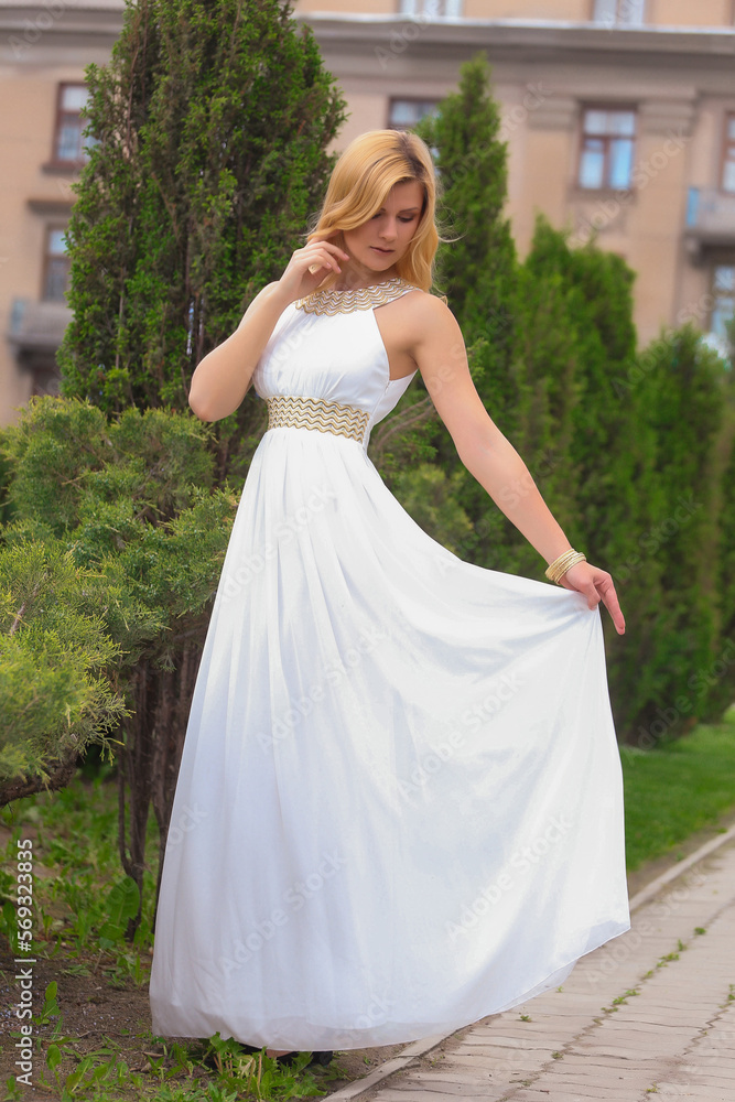 blonde beautiful natural girl with blonde hair in a white dress in nature, on the street, in the garden by a tree, with makeup and hairstyle, greek woman in a white ethnic historical dress, retro blonde beautiful natural girl with blonde hair in a white dress in nature, on the street, in the garden by a tree, with makeup and hairstyle, greek woman in a white ethnic historical dress, retro
