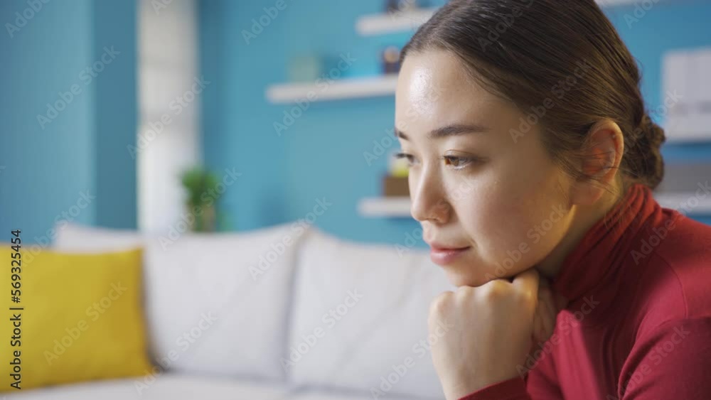 Thoughtful and unhappy Asian woman sitting in living room.
Young Asian woman sitting alone at home looking around thoughtfully.
Thoughtful and unhappy Asian woman sitting in living room.
Young Asian woman sitting alone at home looking around thoughtfully.