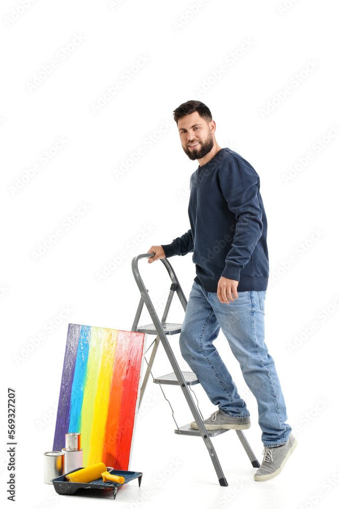 Young man with ladder and painting on white background Young man with ladder and painting on white background