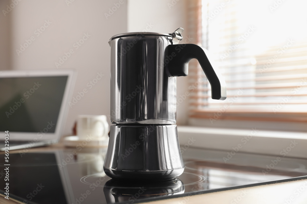 Geyser coffee maker on electric stove in kitchen near window Geyser coffee maker on electric stove in kitchen near window