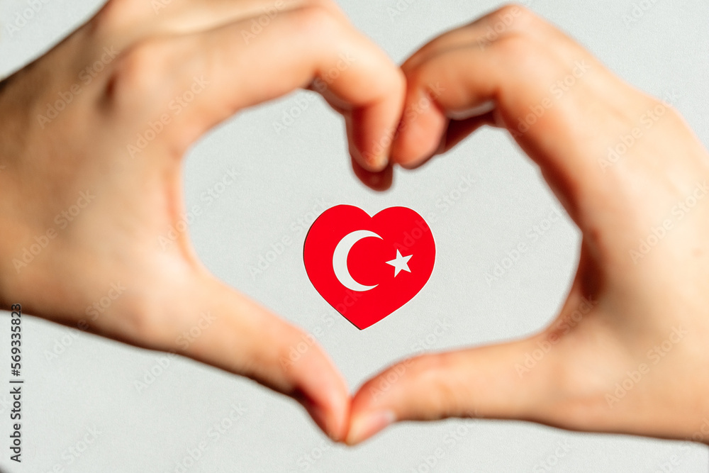 Obraz premium Turkish flag in the form of a heart inside a heart from the hands