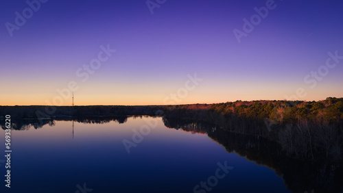 beautiful aerial drone view of a lake sunrise at the blue hour of twilight.