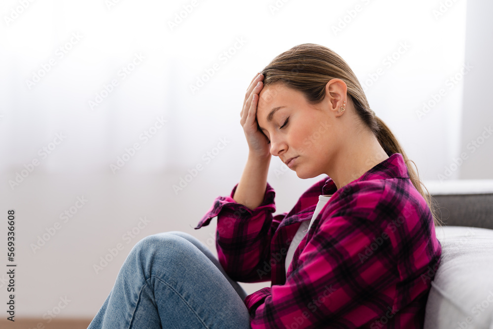 Sad despaired young woman thinking on future while sitting at home Sad despaired young woman thinking on future while sitting at home