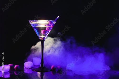 Martini cocktail drink splash with ice cubes in neon iridescent pink and blue colors. Minimal night party life concept.