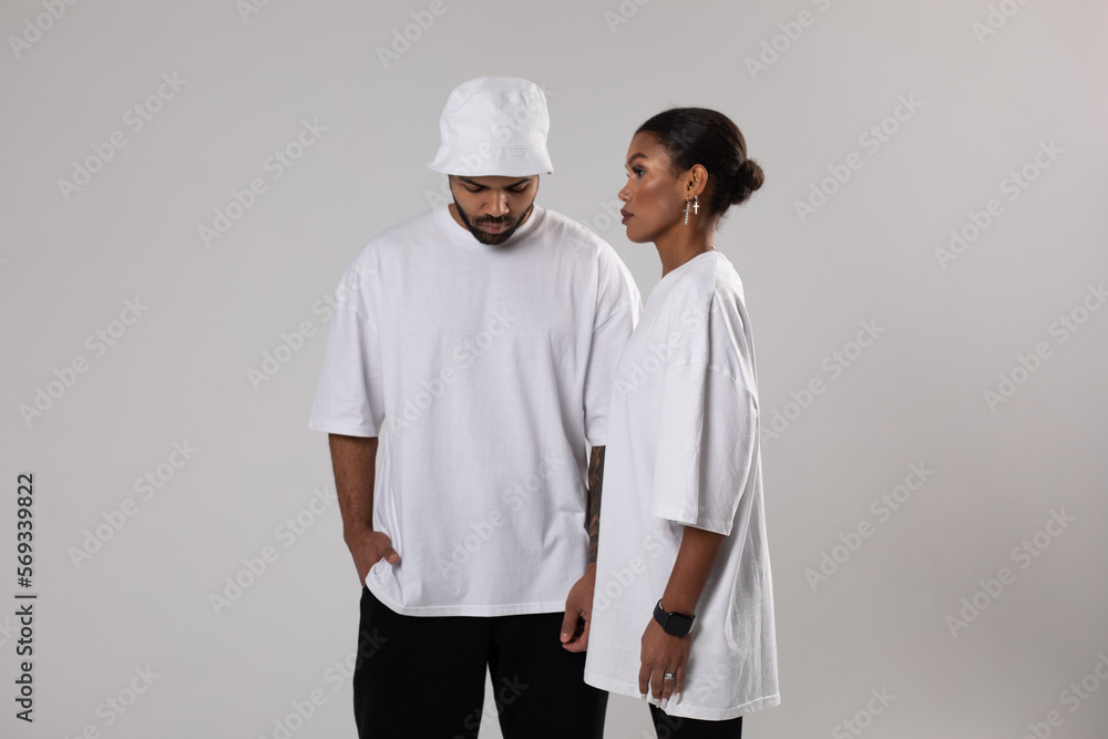 African american couple in white t-shirts. Man in white panama. Mock-up. African american couple in white t-shirts. Man in white panama. Mock-up.