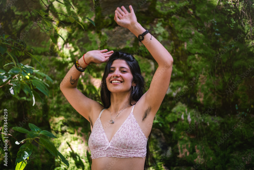 Happy young woman showing her armpit hair in the nature Happy young woman showing her armpit hair in the nature