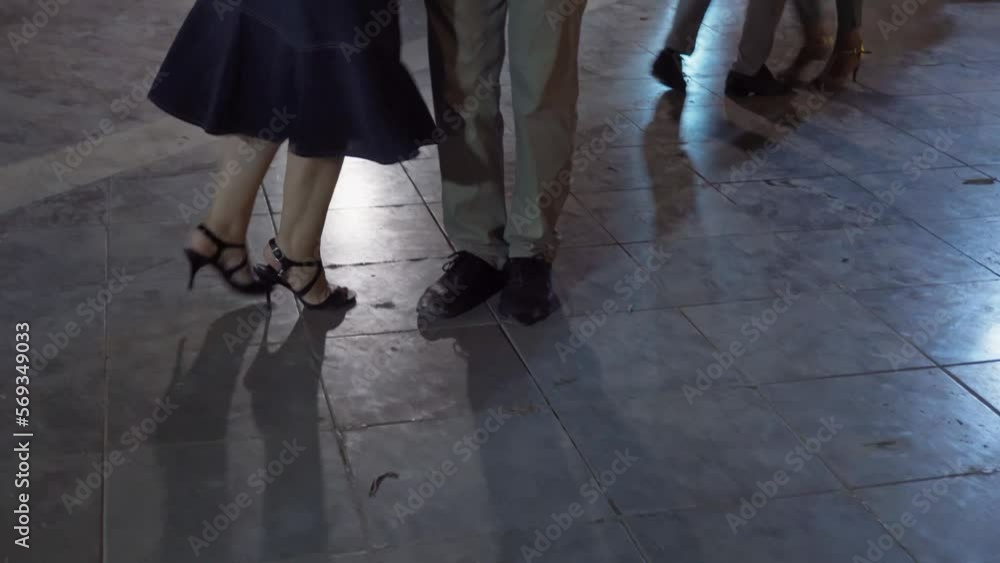 On the street in the park people dance tango. Close-up of the legs. On the street in the park people dance tango. Close-up of the legs.