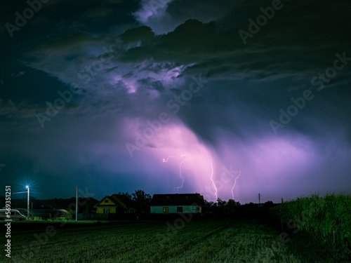 Lightning storm over a rural area lits up the sky at night