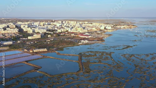 Beautiful aerial views of the Ria Formosa of the Portuguese southern town of Faro, with salt lakes and houses. Drone movement forward