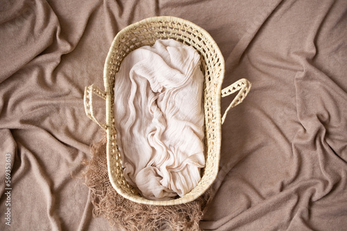 beige photophone for shooting newborns with a beautiful wicker basket