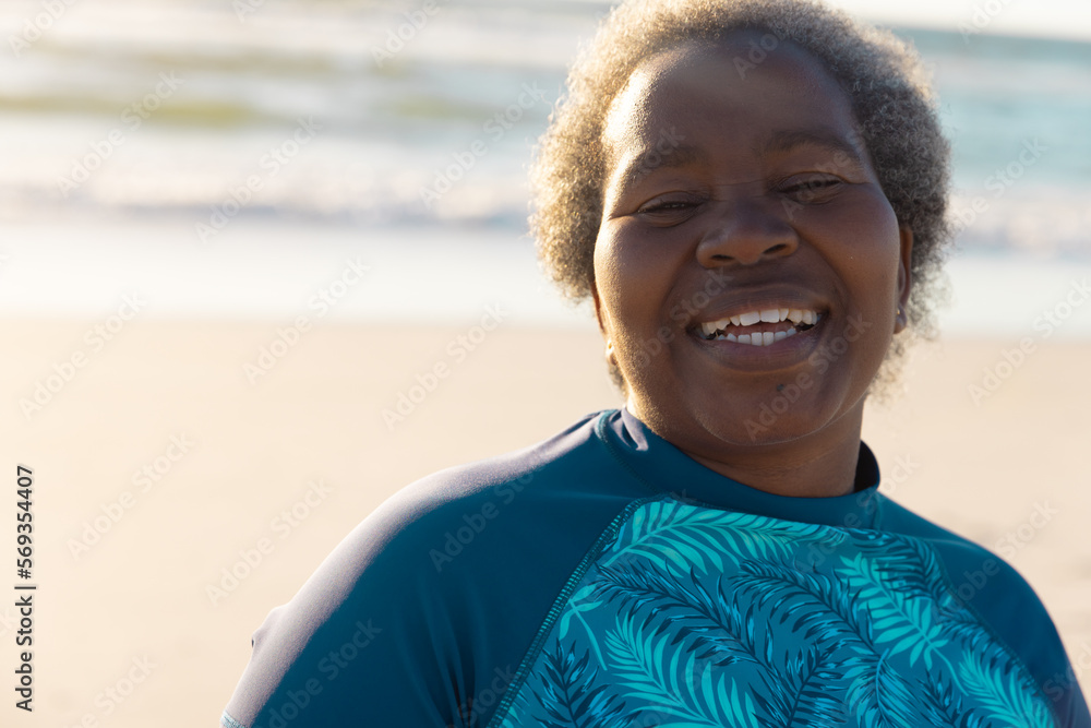 Portrait of happy african american senior woman with gray short hair against seascape during sunset Portrait of happy african american senior woman with gray short hair against seascape during sunset