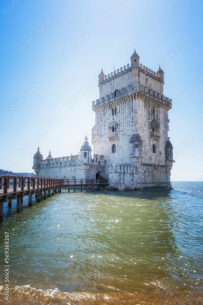 Belem defensive tower in the estuary of the Tagus river in Lisbon, footbridge over the water that leads to the interior, vertical