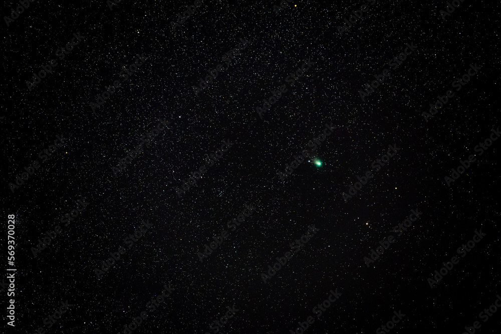 The green comet C/2022 E3 (ZTF) in the constellation Auriga tracked 25 seconds at ISO 2500 in the cold winter night sky with 200mm f2.8 lens, near Darmstadt on February 7th 2023, Germany - obrazy, fototapety, plakaty 