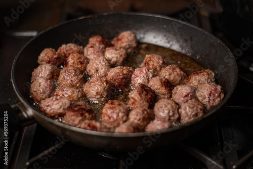 meatballs in a frying pan. Dark background.