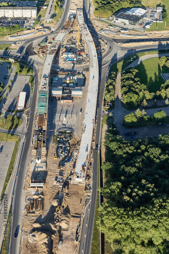 Construction of a new bridge in the city center, view from above. construction machinery is working on laying new asphalt. Marking and pavement Construction of a new bridge in the city center, view from above. construction machinery is working on laying new asphalt. Marking and pavement