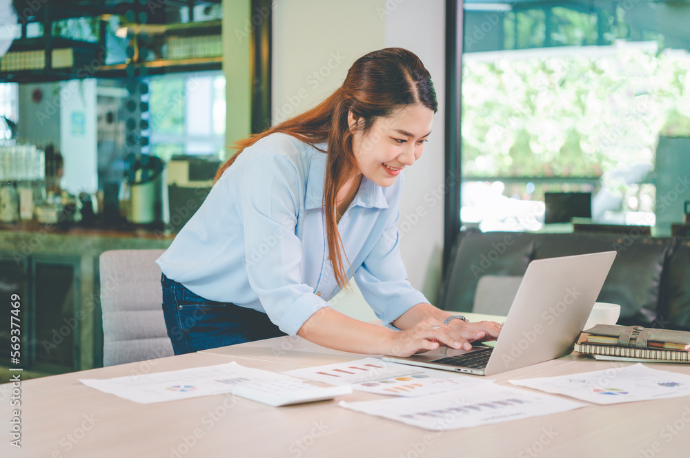 Asian business woman working using laptop for do math finance on wooden desk, tax, accounting, statistics and analytical research concept Asian business woman working using laptop for do math finance on wooden desk, tax, accounting, statistics and analytical research concept