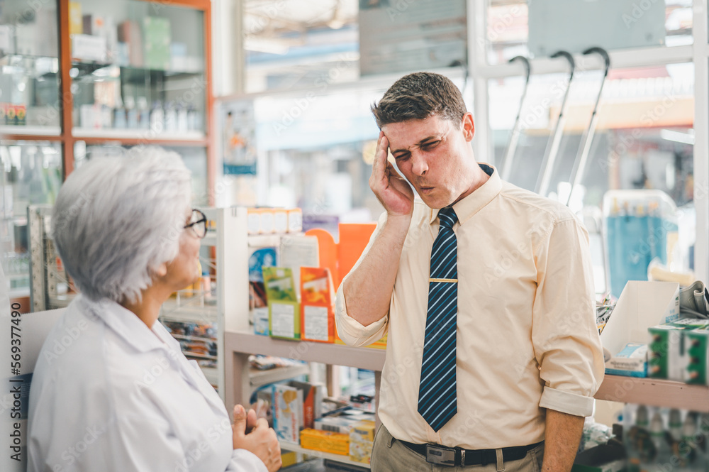 pharmacist is asking about a patient's condition in order to prescribe medication according to the patient's symptoms who come for prescription consultation in a modern pharmacy. pharmacist is asking about a patient's condition in order to prescribe medication according to the patient's symptoms who come for prescription consultation in a modern pharmacy.