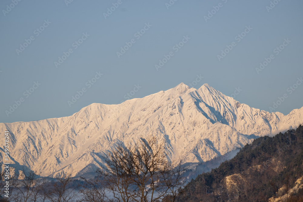 朝日を受け輝く雪山の眺望
