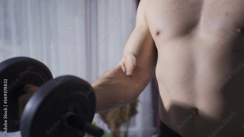 Muscular athlete using dumbbells for arm muscle. Athletic man exercising at home.
Young bodybuilder man is working to make his arm muscles bigger.
Muscular athlete using dumbbells for arm muscle. Athletic man exercising at home.
Young bodybuilder man is working to make his arm muscles bigger.
