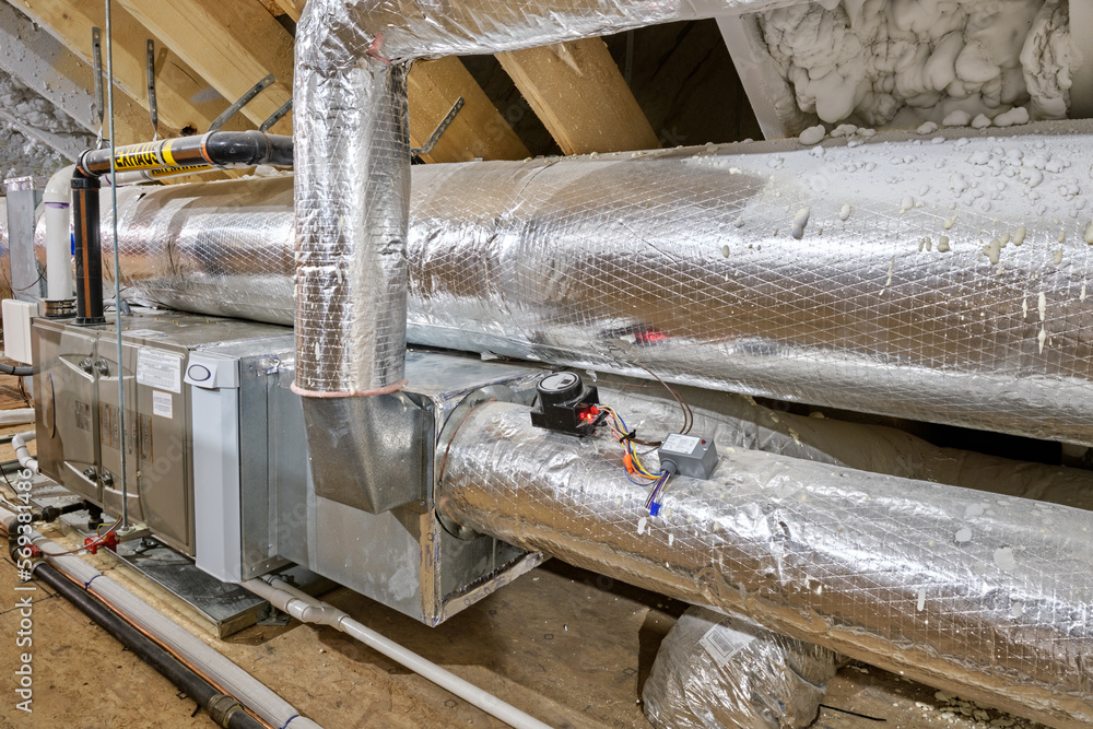 Obraz premium Furnace, air conditioning and duct work in a home's insulated attic