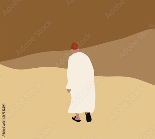 Arab man with traditional emirates clothes walking in massive sand dunes in desert during holiday vacation.