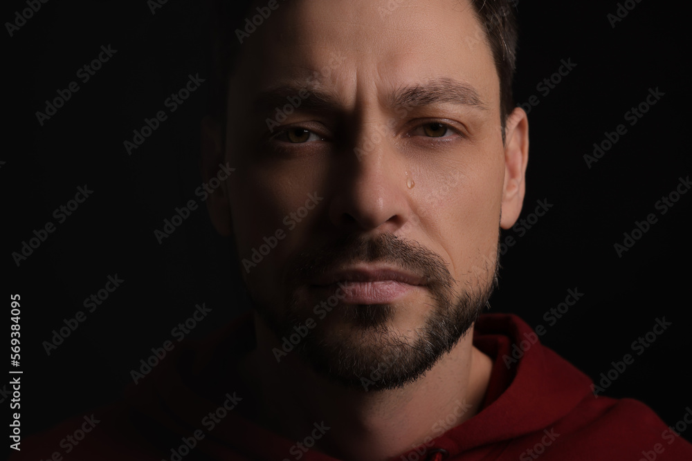 Portrait of sad man on black background Portrait of sad man on black background