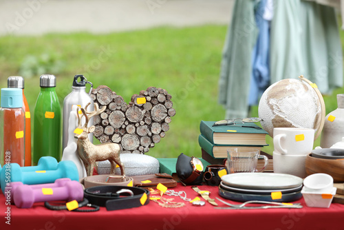 Different items on table outdoors. Garage sale photo