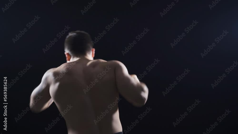 A young man with his back turned shadow boxing at a fast and gentle pace.
Young athlete boxer shadow boxing with his back to the camera.
A young man with his back turned shadow boxing at a fast and gentle pace.
Young athlete boxer shadow boxing with his back to the camera.